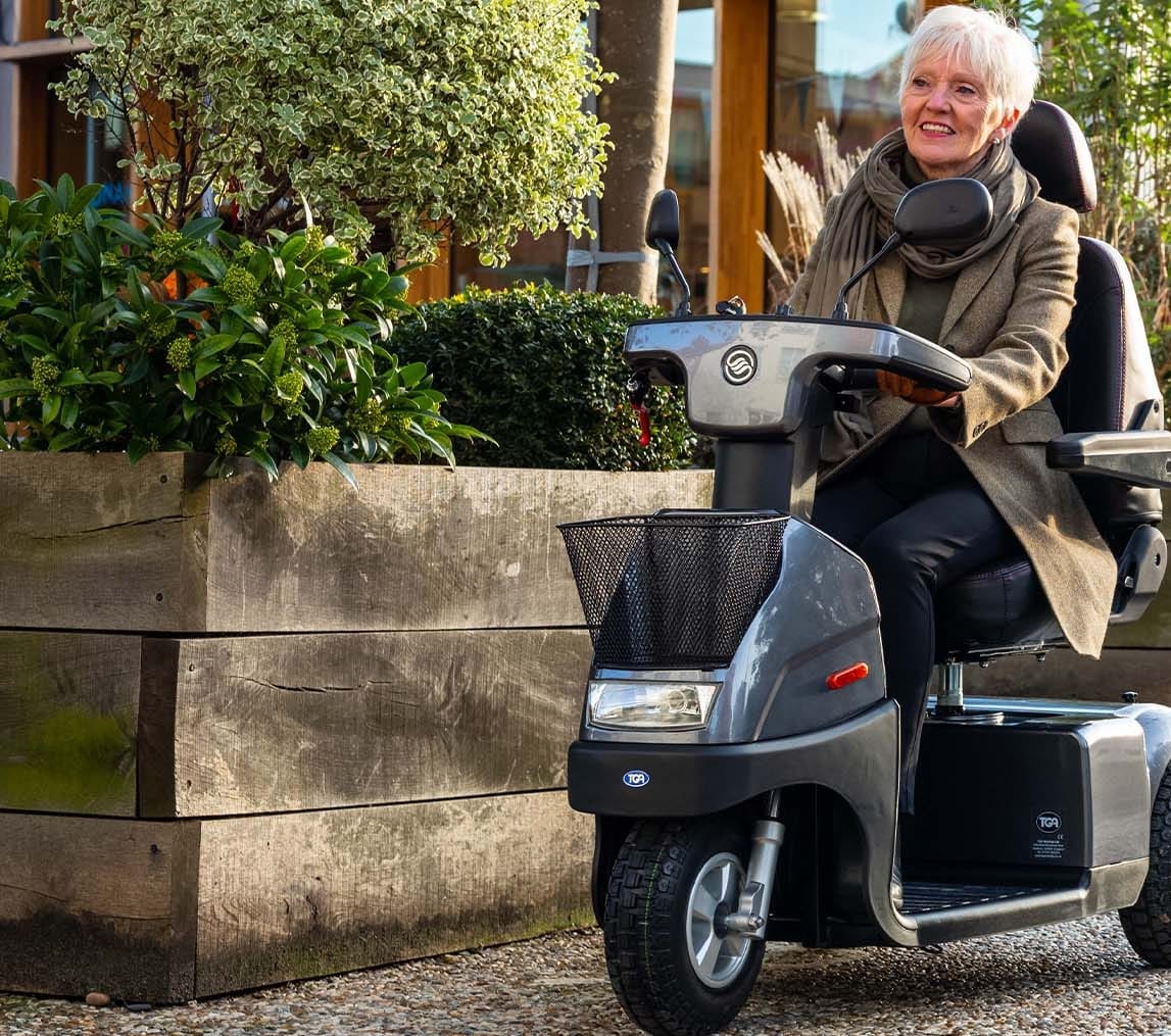 A woman on a 3 wheel mobility scooters