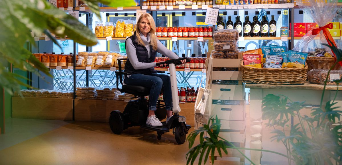 A person sitting on a mobility scooter in a bar